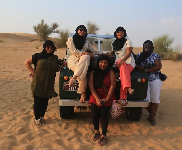 Friends on a vintage truck in the Dubai desert